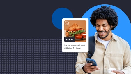 A man checking his phone with an inset of an offer for a chicken sandwich